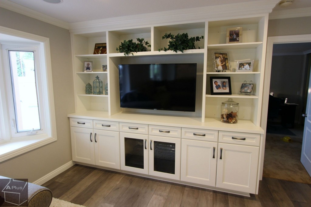 Entrtainment center with custom white cabinets